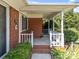 Covered brick front porch with white pillars, offering a cozy outdoor space at 331 Elwood St, Kannapolis, NC 28081