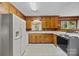 Classic kitchen with wooden cabinets, white countertops, and a standard white refrigerator at 331 Elwood St, Kannapolis, NC 28081