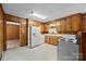 Functional kitchen with wood cabinets, white appliances, and vintage flooring at 331 Elwood St, Kannapolis, NC 28081