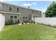 Spacious backyard with lush green grass, white fence, and a patio ideal for outdoor living at 342 Battery Cir, Clover, SC 29710