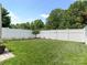 Well-maintained backyard with a manicured lawn, privacy fence, and garden beds at 342 Battery Cir, Clover, SC 29710