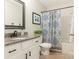 Charming bathroom showcasing a granite vanity, a patterned shower curtain, and neutral tile flooring at 342 Battery Cir, Clover, SC 29710