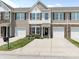 Charming townhome featuring stone accents, brown shutters, and a well-manicured front yard with flower beds at 342 Battery Cir, Clover, SC 29710