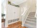 Welcoming hallway featuring a storage cabinet, leading to a staircase with carpet at 342 Battery Cir, Clover, SC 29710
