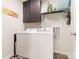 Efficient laundry room with appliances, storage cabinets, and shelves for organizing cleaning supplies at 342 Battery Cir, Clover, SC 29710
