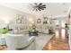 Bright living room with hardwood floors, neutral-toned couches, and a ceiling fan at 342 Battery Cir, Clover, SC 29710