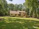 Expansive backyard features a large lawn, mature trees and a wooden deck at 3701 Bounty Ct, Matthews, NC 28104