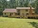 Exterior shot of a house featuring a spacious, well-manicured backyard and deck at 3701 Bounty Ct, Matthews, NC 28104