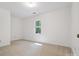 Clean bedroom features a plush carpet, a large window, and neutral paint at 3701 Bounty Ct, Matthews, NC 28104