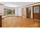 Open dining room area with beautiful hardwood floors, bright windows, and access to the staircase at 3701 Bounty Ct, Matthews, NC 28104