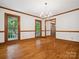 Bright dining room with hardwood floors, classic chandelier, and large windows offering outdoor views at 3701 Bounty Ct, Matthews, NC 28104