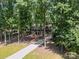 A long driveway leads to this beautiful home surrounded by lush trees at 3701 Bounty Ct, Matthews, NC 28104