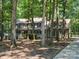 A well-maintained home with a charming front porch nestled among mature trees at 3701 Bounty Ct, Matthews, NC 28104