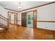 Inviting foyer with hardwood floors, staircase, and a view of the front porch at 3701 Bounty Ct, Matthews, NC 28104