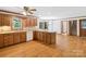 Spacious kitchen with a breakfast bar, wood cabinets, and a view into the dining area and stairway at 3701 Bounty Ct, Matthews, NC 28104