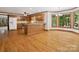 Kitchen featuring hardwood floors, stainless appliances, a breakfast bar, and view to bright dining area at 3701 Bounty Ct, Matthews, NC 28104