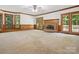 Cozy living room with a brick fireplace, wood paneling, and access to the deck at 3701 Bounty Ct, Matthews, NC 28104