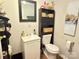 Cozy bathroom with a white vanity, modern fixtures, and convenient toilet storage at 409 W Norment Ave, Gastonia, NC 28052