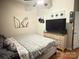A modern bedroom with neutral tones, complemented by artwork and a minimalist design at 409 W Norment Ave, Gastonia, NC 28052