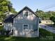 The side exterior features gray siding and a dark roof, highlighting the home's classic appeal at 409 W Norment Ave, Gastonia, NC 28052