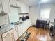Bright kitchen with white cabinets, granite countertops, and a cozy breakfast nook near the window at 409 W Norment Ave, Gastonia, NC 28052