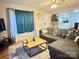 Comfortable living room showcases a large window, a stylish area rug, and a cozy sectional sofa at 409 W Norment Ave, Gastonia, NC 28052
