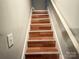 Stairway with wooden steps and a light-colored handrail, leading to the upper level at 409 W Norment Ave, Gastonia, NC 28052