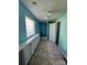 Bright bathroom features blue walls, tile floors, ample cabinet space, and a glass block window for natural light at 417 Garret Ln, York, SC 29745