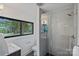 Modern bathroom featuring a glass enclosed shower, stylish fixtures, and a window with natural light at 4209 Windwood Cir, Charlotte, NC 28226