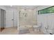 Modern bathroom with a glass-enclosed shower, built-in bench, and neutral tile at 4209 Windwood Cir, Charlotte, NC 28226