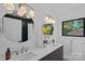 Elegant bathroom with double sinks, modern lighting, and stylish fixtures at 4209 Windwood Cir, Charlotte, NC 28226
