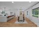 Open concept dining area with modern chandelier, neutral colors, and natural light from large windows at 4209 Windwood Cir, Charlotte, NC 28226