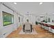 Spacious dining room with hardwood floors, contemporary lighting, and great natural light at 4209 Windwood Cir, Charlotte, NC 28226