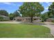 Beautiful home with large front yard and inviting covered porch, perfect for enjoying the outdoors and curb appeal at 4209 Windwood Cir, Charlotte, NC 28226