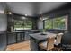 Modern kitchen with gray cabinetry, wine fridge, and a view to the landscaped backyard at 4209 Windwood Cir, Charlotte, NC 28226