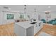 Modern kitchen featuring an island with seating, stainless steel dishwasher, and an open view to the dining area at 4209 Windwood Cir, Charlotte, NC 28226