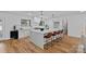 Bright and open kitchen featuring a large island with seating, stainless steel appliances, and hardwood flooring at 4209 Windwood Cir, Charlotte, NC 28226