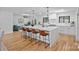 Bright open-concept kitchen features a large quartz island, modern appliances, and hardwood floors at 4209 Windwood Cir, Charlotte, NC 28226
