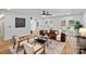 Inviting living room featuring hardwood floors, a leather couch, and access to the backyard at 4209 Windwood Cir, Charlotte, NC 28226