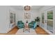 Cozy living room features hardwood flooring, comfortable seating, and an open doorway to the outside at 4209 Windwood Cir, Charlotte, NC 28226