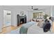 Cozy main bedroom with fireplace, ceiling fan, and natural light from the window at 4209 Windwood Cir, Charlotte, NC 28226