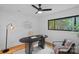 Home office space featuring wood floors, a modern desk, and a window with natural light and wooded views at 4209 Windwood Cir, Charlotte, NC 28226