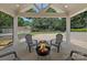 Relaxing outdoor patio with fire pit and seating; perfect for entertaining friends and Gathering with a lovely backyard view at 4209 Windwood Cir, Charlotte, NC 28226