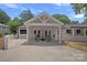 Charming home featuring a covered patio with a fire pit, ideal for outdoor relaxation and gatherings at 4209 Windwood Cir, Charlotte, NC 28226