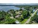 Aerial image showing a lakefront property and a swimming pool surrounded by trees near a main road at 4278 Harbor Ln, Sherrills Ford, NC 28673