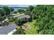 Aerial view showing a beautiful landscape, mature trees, a screened-in porch and lake views at 4278 Harbor Ln, Sherrills Ford, NC 28673