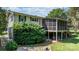 Backyard featuring a lush lawn, mature trees, landscaped flowerbeds and a screened-in porch attached to the home at 4278 Harbor Ln, Sherrills Ford, NC 28673