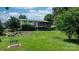 Expansive backyard featuring a lush lawn, mature trees, and a screened-in porch attached to the home at 4278 Harbor Ln, Sherrills Ford, NC 28673