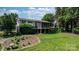 Expansive backyard featuring a lush lawn, mature trees, and a screened-in porch attached to the home at 4278 Harbor Ln, Sherrills Ford, NC 28673