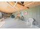 View of a concrete basement with painted walls, a bench, decor, and access to an outdoor screened-in area at 4278 Harbor Ln, Sherrills Ford, NC 28673